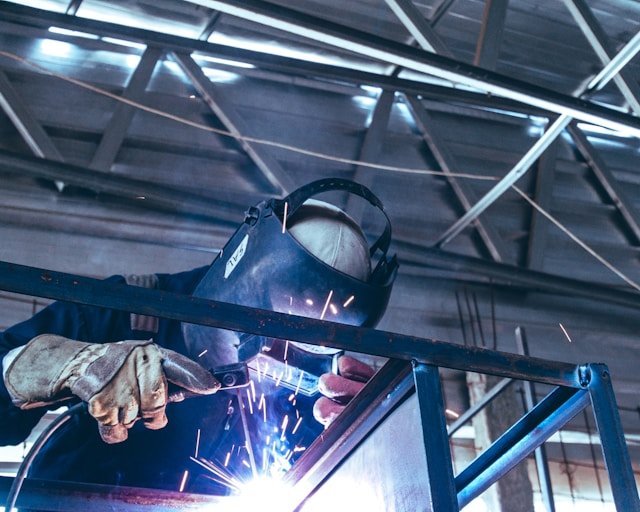 Welder working on metal frame