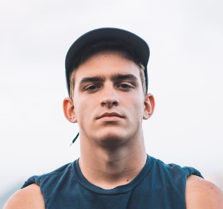 Man in black cap staring ahead